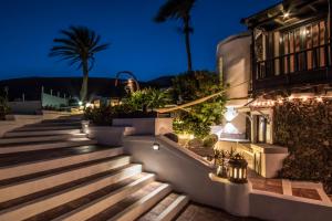 a set of stairs leading to a building at night at Deluxe designer historic villa Via Lactea, Panoramic sea views, Own private heated pool and subtropical garden in La Asomada