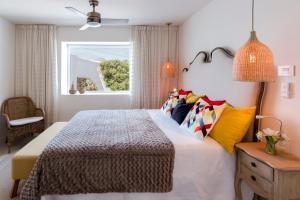 a bedroom with a large bed and a window at Deluxe designer historic villa Via Lactea, Panoramic sea views, Own private heated pool and subtropical garden in La Asomada +25 photos