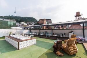 a rooftop patio with a sink and chairs on a building at The Cube Hotel in Seoul