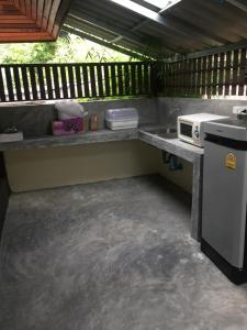 an outdoor kitchen with a counter and a stove at Lucky Resort in Haad Yao