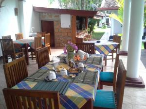 a table with plates of food on top at White Bridge House & Resort in Aluthgama