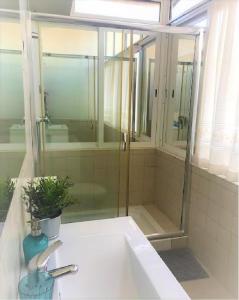 a bathroom with a glass shower and a sink at casa largo do cruzeiro in Peso da Régua