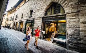 a man and a woman walking down a street at Locanda Mimmo in Bergamo