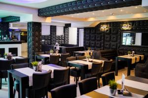 a restaurant with tables and chairs and a bar at Olympic Apartments& Spa in Belgrade