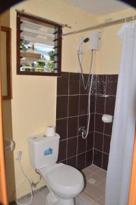 a bathroom with a toilet and a shower at Sf Cantina in Bantayan Island