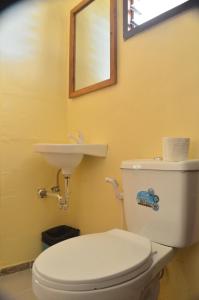 a bathroom with a white toilet and a sink at Sf Cantina in Bantayan Island