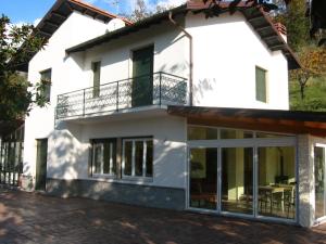 a white house with large windows and a balcony at Agriturismo Valdolivo in Cogoleto +24 photos