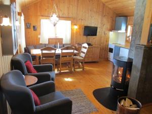 a living room with a dining table and a fireplace at Hogstul Hytter - Skojestua - 2 Bedroom Cottage in Tuddal