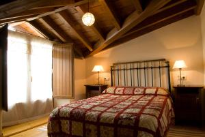 a bedroom with a bed and a large window at Casa rural La Rasa in Cabezas Altas
