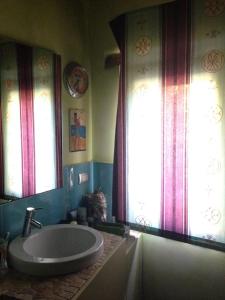 a bathroom with a large tub and two windows at Stone farmhouse in Moie in Moie