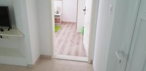 an open door to a room with a wooden floor at Apartment Petra in Szlatina