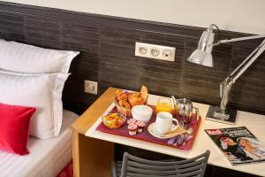 a tray of food on a table in a hotel room at Hotel Antin Trinité in Paris