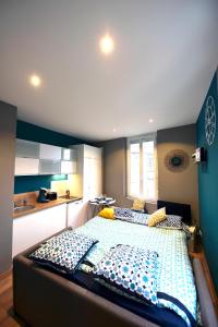 a bedroom with a large bed in a kitchen at Appartement "l'Univers Marin" - 50m Front de Mer in Berck-sur-Mer +41 photos