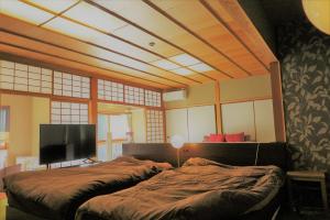 Un ou plusieurs lits dans un hébergement de l'établissement OkutsuHotSpa IkedayaKajikaen