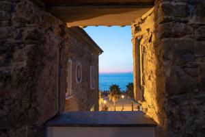 a view of the ocean from a building at night at Residenza d'epoca Olimpia in Santa Maria di Castellabate