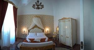 a bedroom with a king sized bed and a dresser at Palermo Gallery in Palermo
