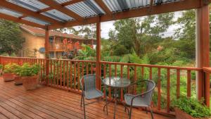 a wooden deck with a table and chairs on it at The 2C's Bed & Breakfast in Cygnet