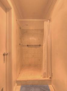 a shower with a shower curtain in a bathroom at The 2C's Bed & Breakfast in Cygnet