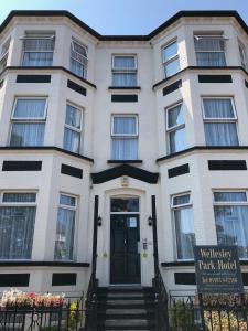 a large white building with a sign in front of it at Wellesley Park Hotel in Great Yarmouth