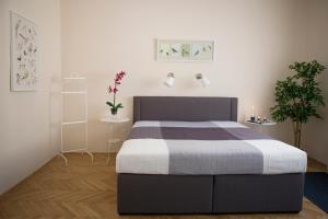 a bedroom with a bed and two plants at Synagogue View Apartment in Budapest