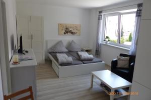 a living room with a couch and a table at Haus am Bach in Fulpmes