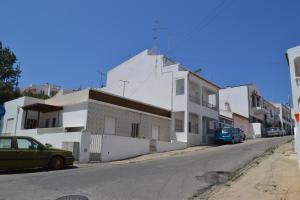 a white building on the side of a street at Casa Amado in Lagos