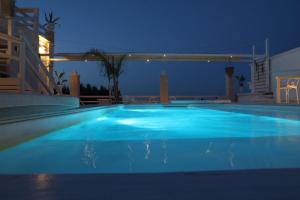 a large blue swimming pool at night at Playa del Mar - Adults Only in Monopoli