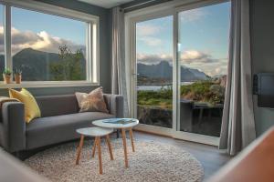 a living room with a couch and a large window at Lofoten view in Kabelvåg