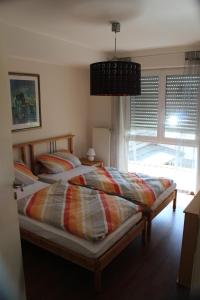 a bedroom with a bed and a large window at Ferienwohnung Tropical in Vendersheim