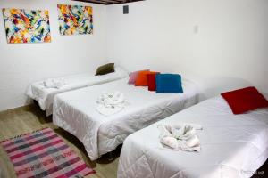 Säng eller sängar i ett rum på Pousada das Acerolas