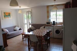 a living room with a table and a couch at Apartment in Rota Cadiz, Air Cond, Wifi, Patio in Rota