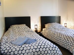 two beds sitting next to each other in a bedroom at Gîte Les Clapas in Boissières +5 photos