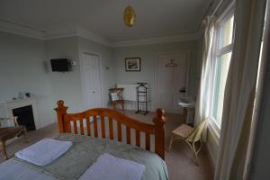 a bedroom with a bed and a large window at Severn House in Watchet