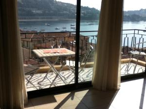a view of a balcony with a table and chairs at The Dina Palace. in Villefranche-sur-Mer