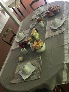 a table with a green table cloth with food on it at Au Vieux Logis 63 in Saint-Rémy-sur-Durolle