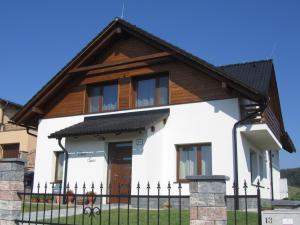 a house with a fence in front of it at Casa Spas in Horná Mičiná