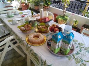 a table with food and drinks on it at La Castellese in Aci Castello