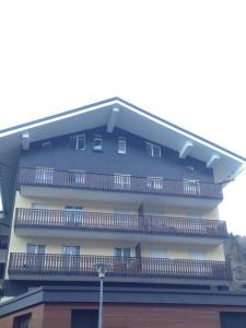 a building with balconies on the side of it at Mountain Charming Studio in Madesimo