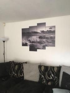 a living room with five paintings on the wall at 5 Shell Hill Mews in Coleraine