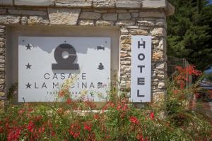 a sign for a casa al marina on a stone wall at Casale La Macina - Hotel, Scopello in Scopello