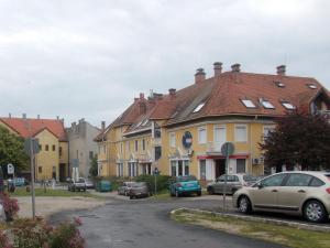 a group of houses with cars parked on a street at Joel Swiss Apartman in Keszthely
