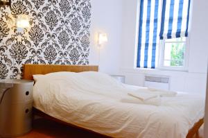 Кровать или кровати в номере Quatre Chaises