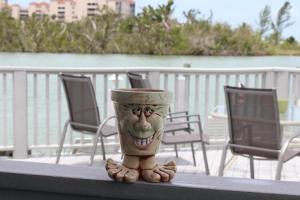 a cup with a face on it sitting on a table at The BoatHouse in Marco Island