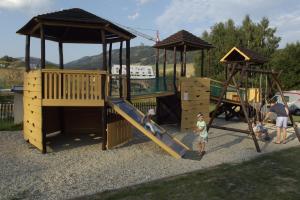 a group of children playing on a playground at Apartmán U Sjezdovky in Dolní Morava