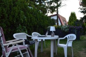 a table and chairs with a laptop on it at Bursztynowa Komnata in Ustka