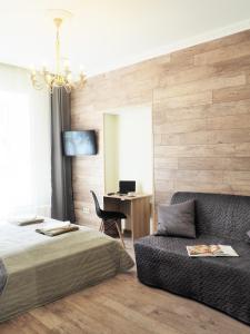 a bedroom with a bed and a chair and a desk at Emi apartment in Vilnius