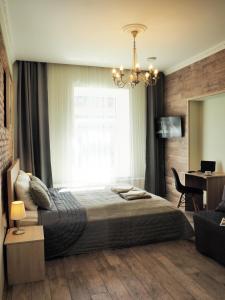 a bedroom with a bed and a window and a desk at Emi apartment in Vilnius