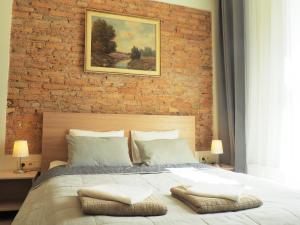 a bedroom with a brick wall and a large bed at Emi apartment in Vilnius