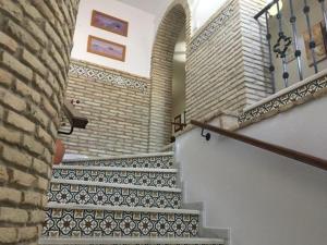 a spiral staircase in a building with a brick wall at Casa Francisco el de Siempre in El Palmar