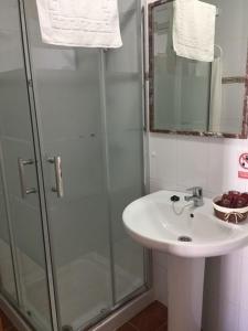 a bathroom with a sink and a glass shower at Casa Francisco el de Siempre in El Palmar